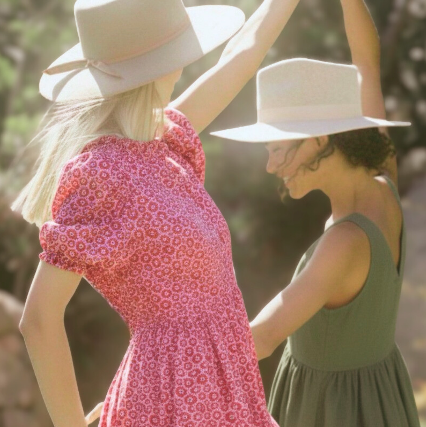 Two women wearing hats with a blurred natural background