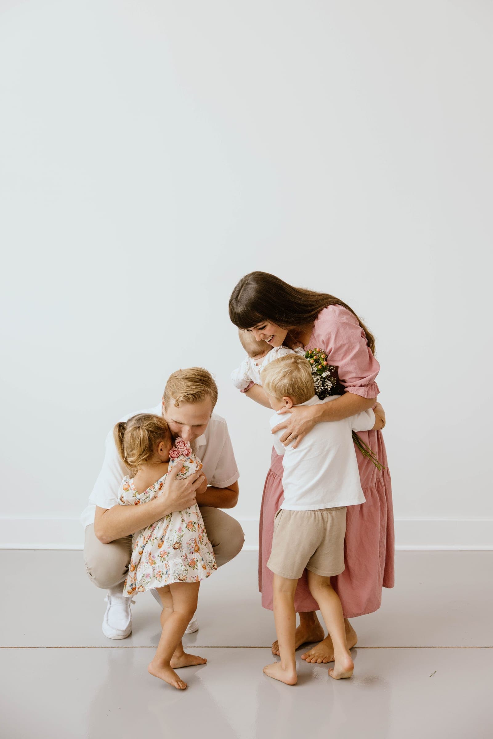 A family embracing, mother in a cotton dress