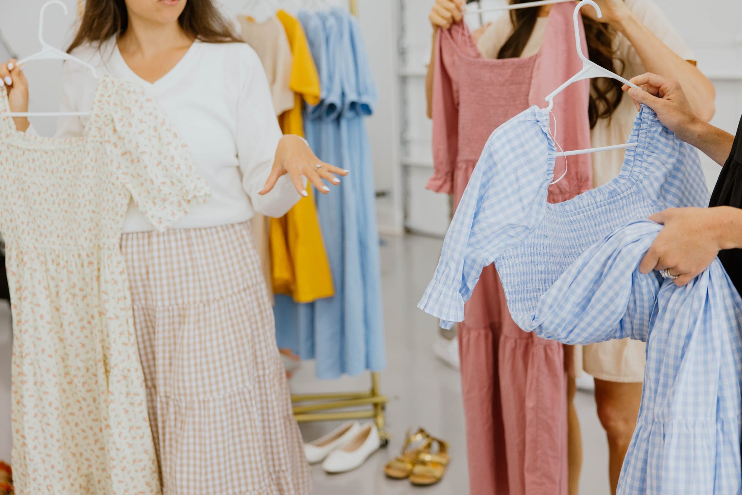 Choosing cotton dresses from a rack
